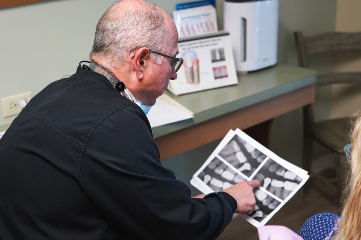Dr. Bergens reviewing X-rays with a patient