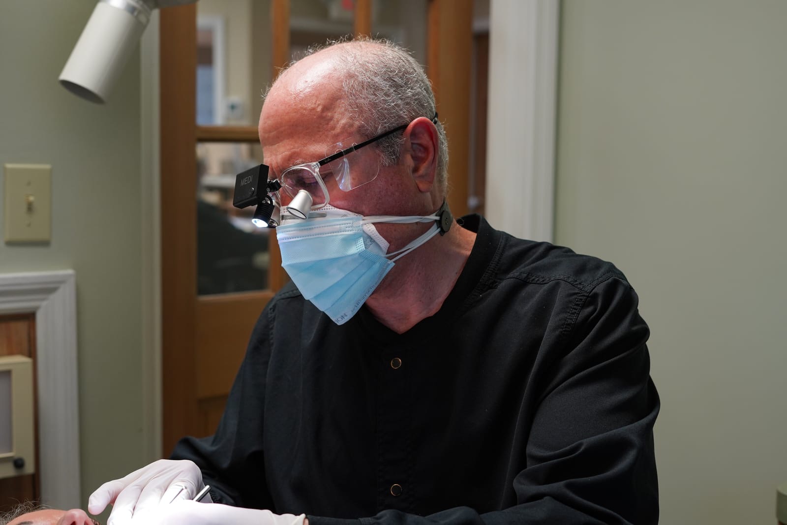 Dr. Bergens working with surgical loupes during a procedure