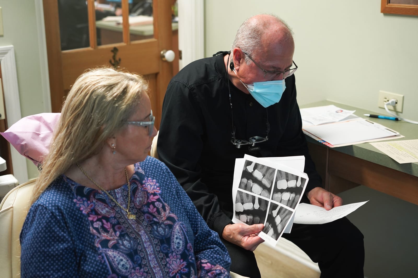Dr. Bergens reviewing X-rays with a patient