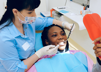 A patient reviewing gum treatment results in the chair