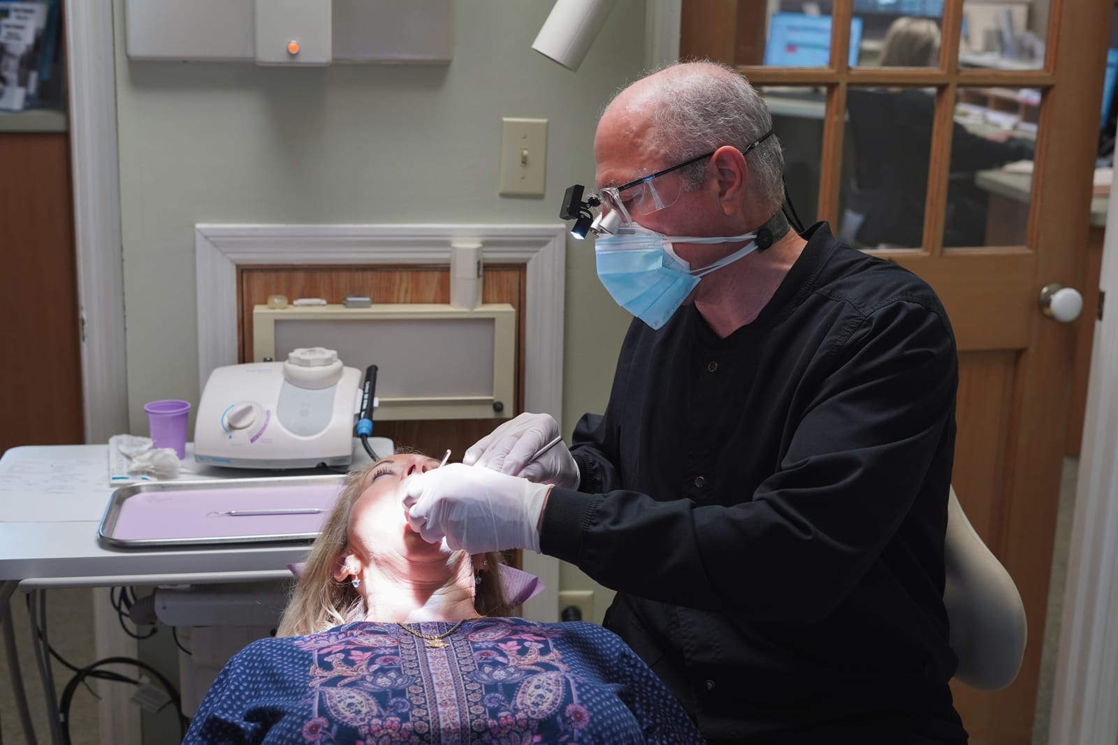 Dr. Bergens providing gum treatment with precision surgical loupes