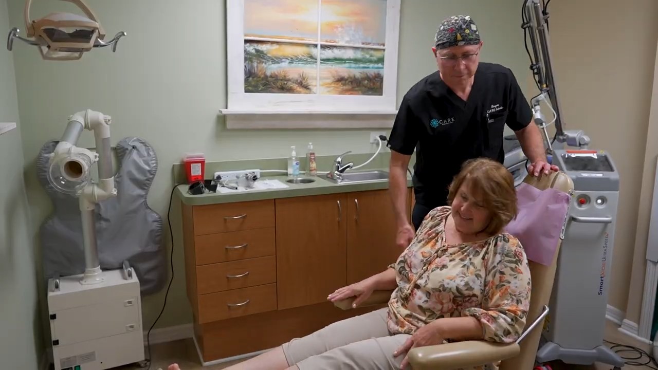 Dr. Bergens welcoming a smiling patient in the treatment room