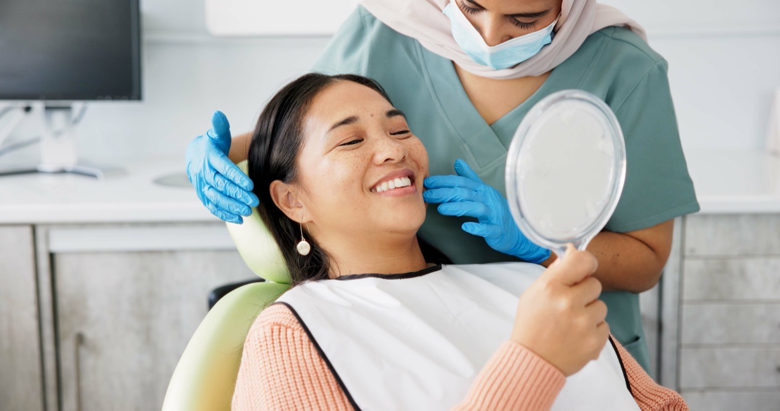 A patient admiring her smile after treatment