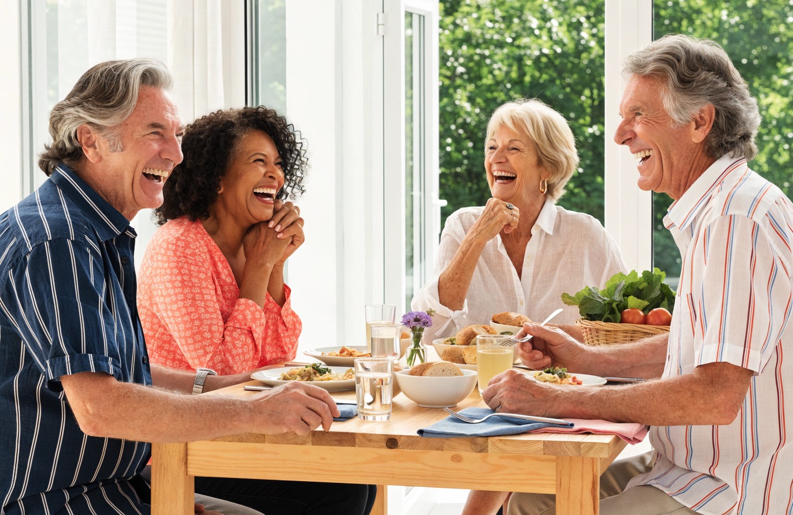 Friends laughing together over a meal